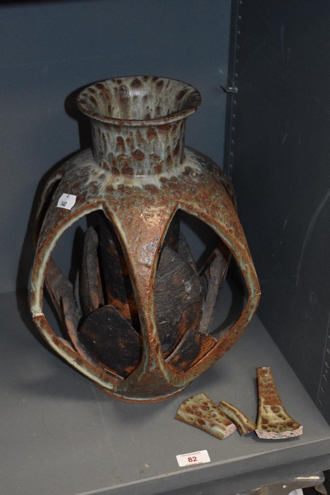 A large and unusual Ambleside pottery vase, having exposed lotus flower shaped form within cage like