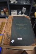 A book, Harmsworth atlas and gazetter, with colour plates, in poor condition.