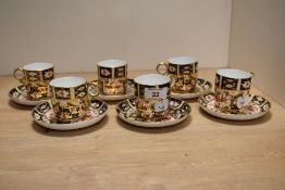 Six Royal Crown Derby coffee cans and saucers, in the Imari pallet, 2451 to base.
