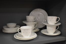 A selection of Susie Cooper cups and saucers, plates and sugar basin, having white ground with
