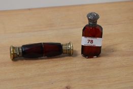 A Victorian ruby glass double ended perfume bottle, having gold tone caps and a similar perfume