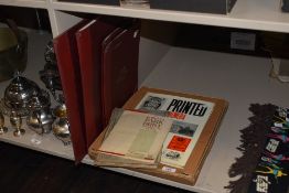 A book on printed ephemera, a copy of the strand magazine, some cigarette cards and four files,