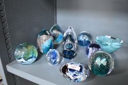 An assortment of paperweights, including Mdina glass and Caithness.