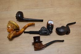 A selection of novelty tobacco pipes, including carved meerschaum pipe depicting ladies head and