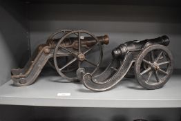 Two decorative small scale cannons.