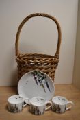 A collection of modern cups, saucers and plates, sold with a wicker hand basket.