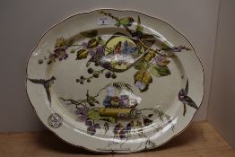 A late 19th/ early 20th century platter, having hand tinted transfer pattern of birds,