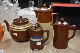 A 20th century teapot having brown glaze and mint and cream bands, similar lidded jug and two