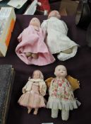 Four early 20th century Dolls, Bisque headed with sleep blue eyes and closed mouth, cloth body,