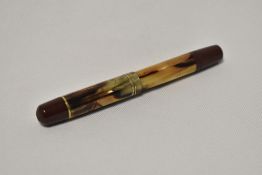 A Pelikan 100N Magnum piston fill fountain pen in Red HR and tortoise with two narrow bands to the