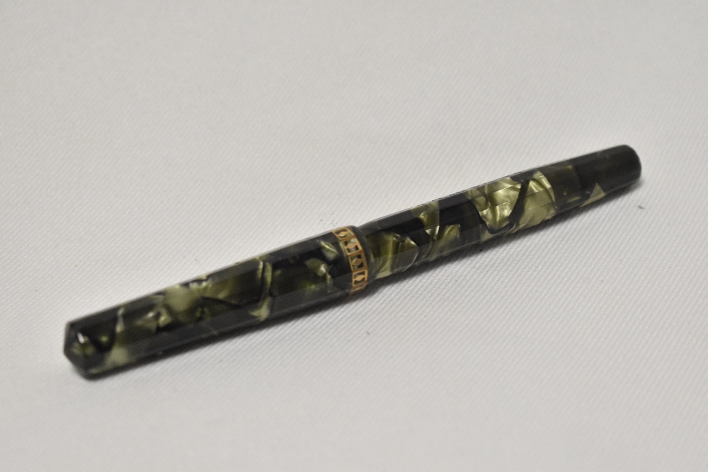 An Eversharp Doric lever fill fountain pen in green marble with dodecahedron faceted cap and barrel,