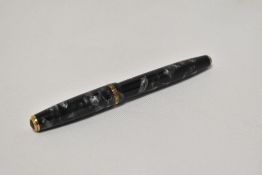 A Parker Duofold button fill fountain pen in black and grey marble with broad decorative band to the