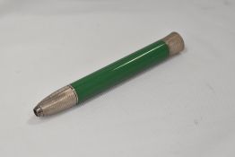 A large propelling crayon in green with hallmarked silver