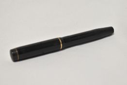 A Mentmore Auto-Flow button fill fountain pen in black with engine turn design single narrow band to