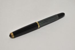 A Pelikan 400 piston fill fountain pen in green and black stripes having Pelikan 14C 585 OB nib.