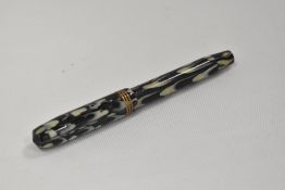 A Guildhall piston fill fountain pen in pearl and black with three narrow bands to the cap having