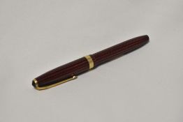 A Conway Stewart 76 lever fill fountain pen in red and black herringbone with broad band to the