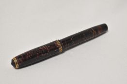 A Parker Vacumatic Standard button fill fountain pen in burgundy with three narrow bands to the