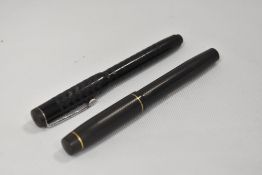 Two National Security lever fill fountain pens in black both with warrented 14ct nibs