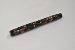 A Kingswood lever fill fountain pen in brown and black marble with single narrow band to the cap