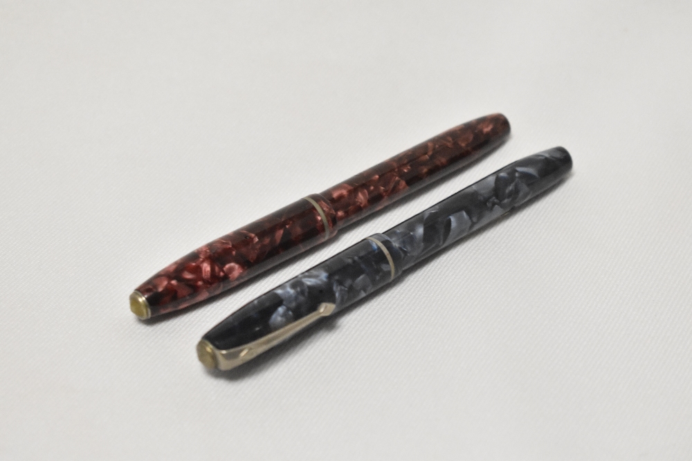 Two Conway Stewart 75 lever fill fountain pens one in rose and black marble the other grey and black