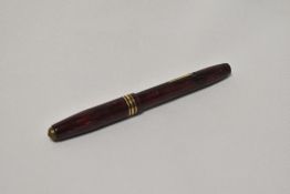 A Conway Stewart 36 lever fill fountain pen in black black and rose striated design with a broad and