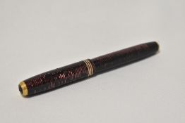 A Parker Vacumatic Jr button fill fountain pen in burgundy with three narrow bands to the cap having