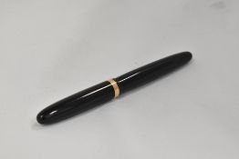 An Omas Extra piston fill fountain pen in black with visible band to barrel and broad band to the