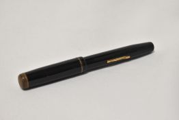 A Mentmore Supreme lever fill fountain pen in black with single narrow band to the cap having