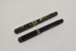 Two Conway Stewart 388 lever fill fountain pens one in black the other in green marble with single