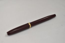A Sheaffer Imperial piston fill fountain pen in burgandy with band to cap edge, no spot having