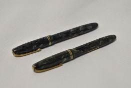 Two Burnham No56 lever fill fountain pens one in green marble the other in grey marble with two
