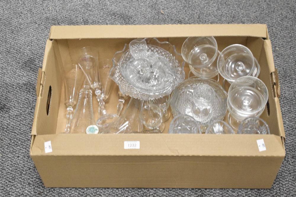 A carton of assorted glassware including a tazza, drinking glasses, avocado dishes, sundae dishes