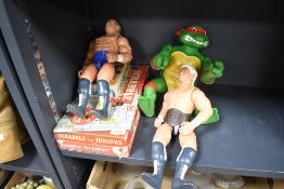 Two 1991 Galloop WCW wrestling figures, Rick Flair and similar, sold with a 1989 Playmates toys