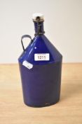 A vintage blue enamel flask with stopper and handle.