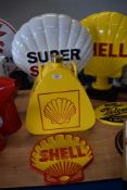 A reproduction Shell sign, Super Shell sign, a jerry can and plaque.