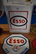 A reproduction Esso can and plaque.
