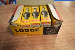 A vintage box of ten Lodge spark plugs.