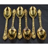 A set of six Queen Elizabeth II silver gilt table or dessert spoons, having oval bowls, cast and