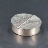 A Queen Elizabeth II 925 grade white metal pill box, of circular form with two hinged demi-lune