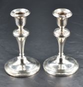 A pair of George V silver candlesticks, of traditional knopped and reeded form with marks for