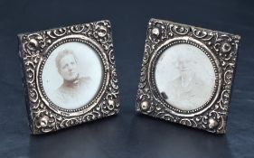 A pair of small late Victorian silver mounted photograph frames, of square form with embossed