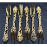 A set of six Queen Elizabeth II silver gilt table forks, having four tapering tines, cast and