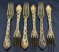 A set of six Queen Elizabeth II silver gilt table forks, having four tapering tines, cast and