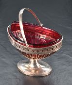 A 19th century white metal sugar bowl, of dished elliptical form with pivoted handle, pierced
