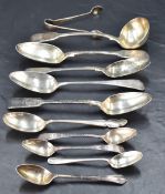 A group of mixed Georgian and later silver spoons, and sauce ladle, various designs ages and makers,