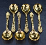 A set of six Queen Elizabeth II silver gilt soup spoons, having rounded bowls, cast and pierced
