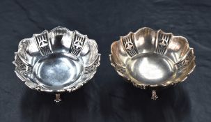 A pair of George V silver pin dishes, of shaped circular form, the embossed bodies decorated with