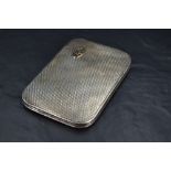 A George V silver cigarette case, of sprung piano hinged rectangular form with bold engine-turned