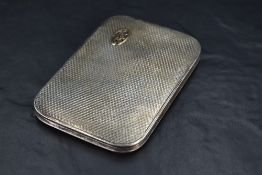A George V silver cigarette case, of sprung piano hinged rectangular form with bold engine-turned